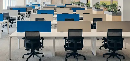 Modern open-plan office space featuring clean workstations, ergonomic chairs, and sanitized carpets provided by professional office cleaning services in St Paul, MN.