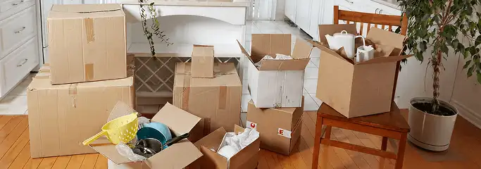 Packed moving boxes and household items in a kitchen before move-out or move-in cleaning, St Paul, MN.